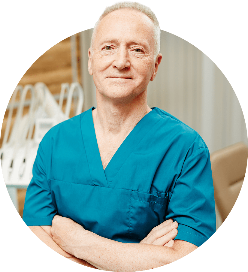 An oral surgeon standing near a dental chair